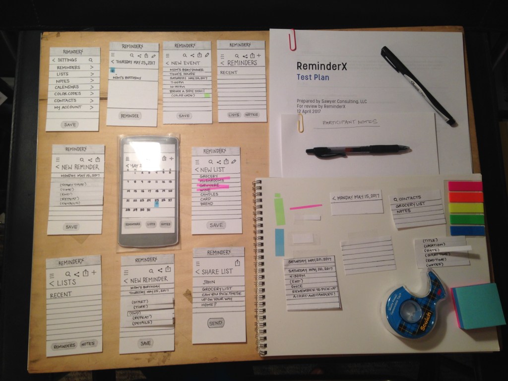 Design materials laid out for testing ReminderX using paper prototypes.